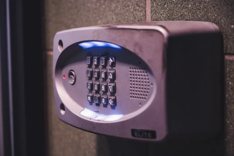 Illuminated security alarm keypad on a wall