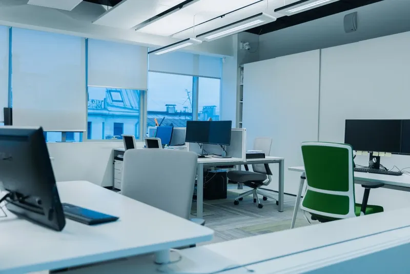 Bright, tidy open-plan office with empty desks
