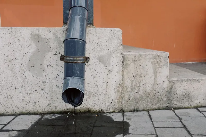 Downpipe leaving water stains on concrete steps