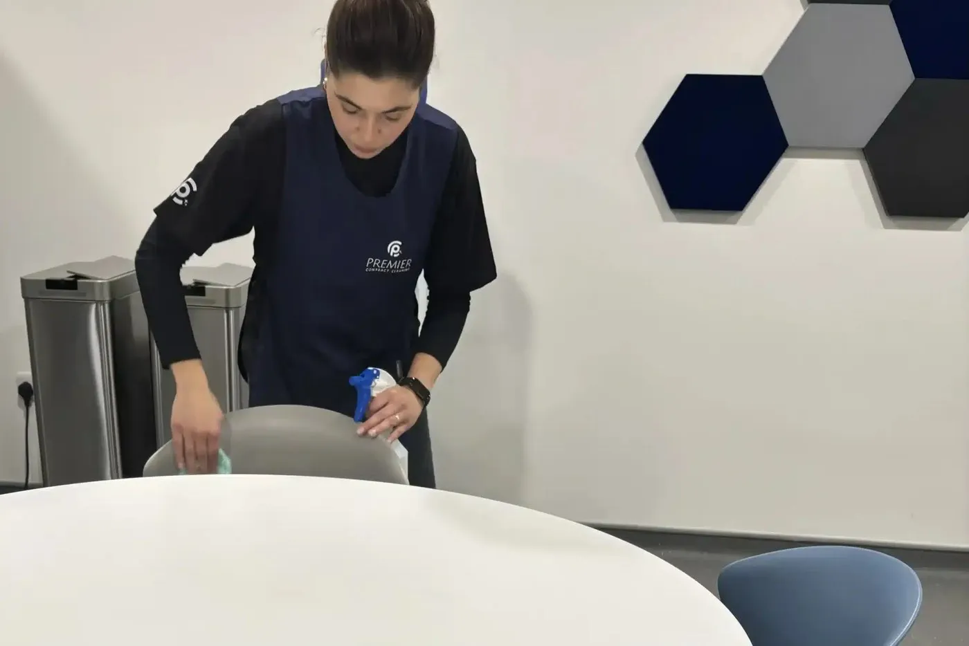 Premier cleaner wiping a meeting room table