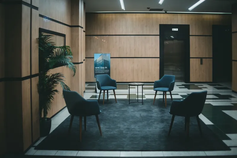 Seating area in an office building lobby beside the lifts