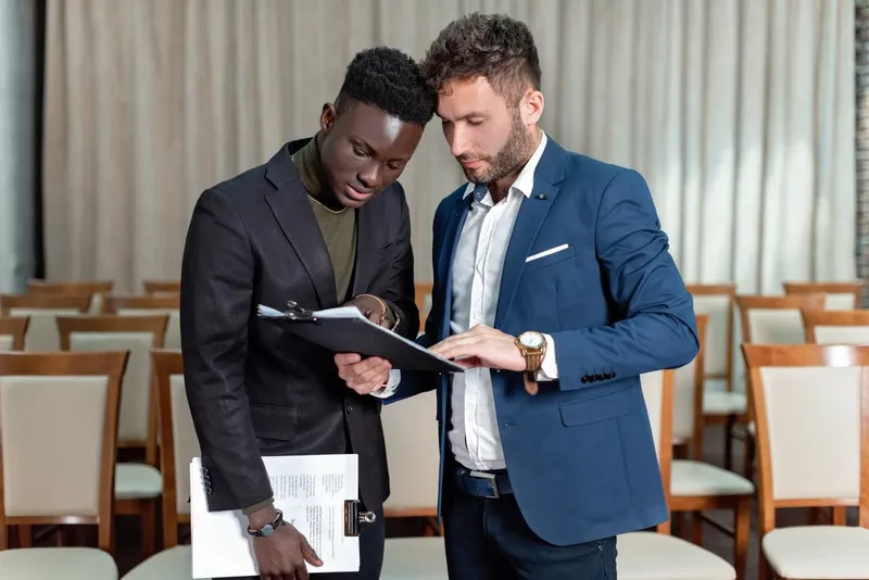 Two businessmen reviewing documents together