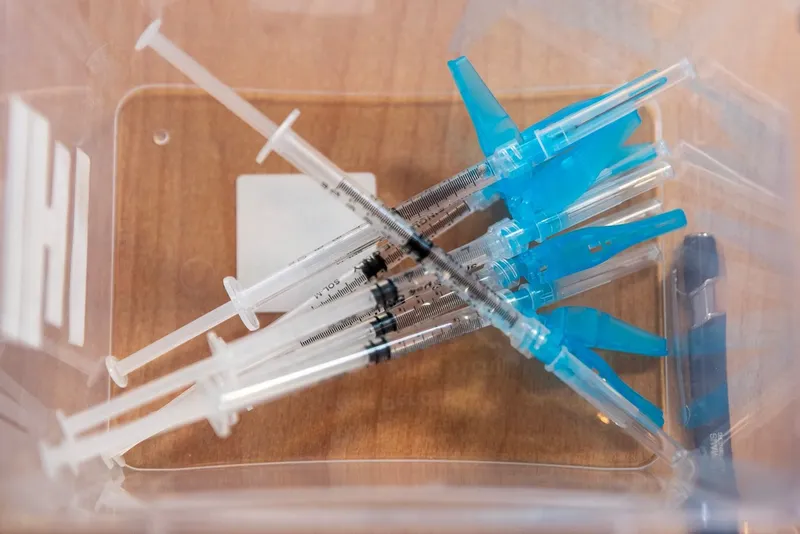 Used syringes in a clear container