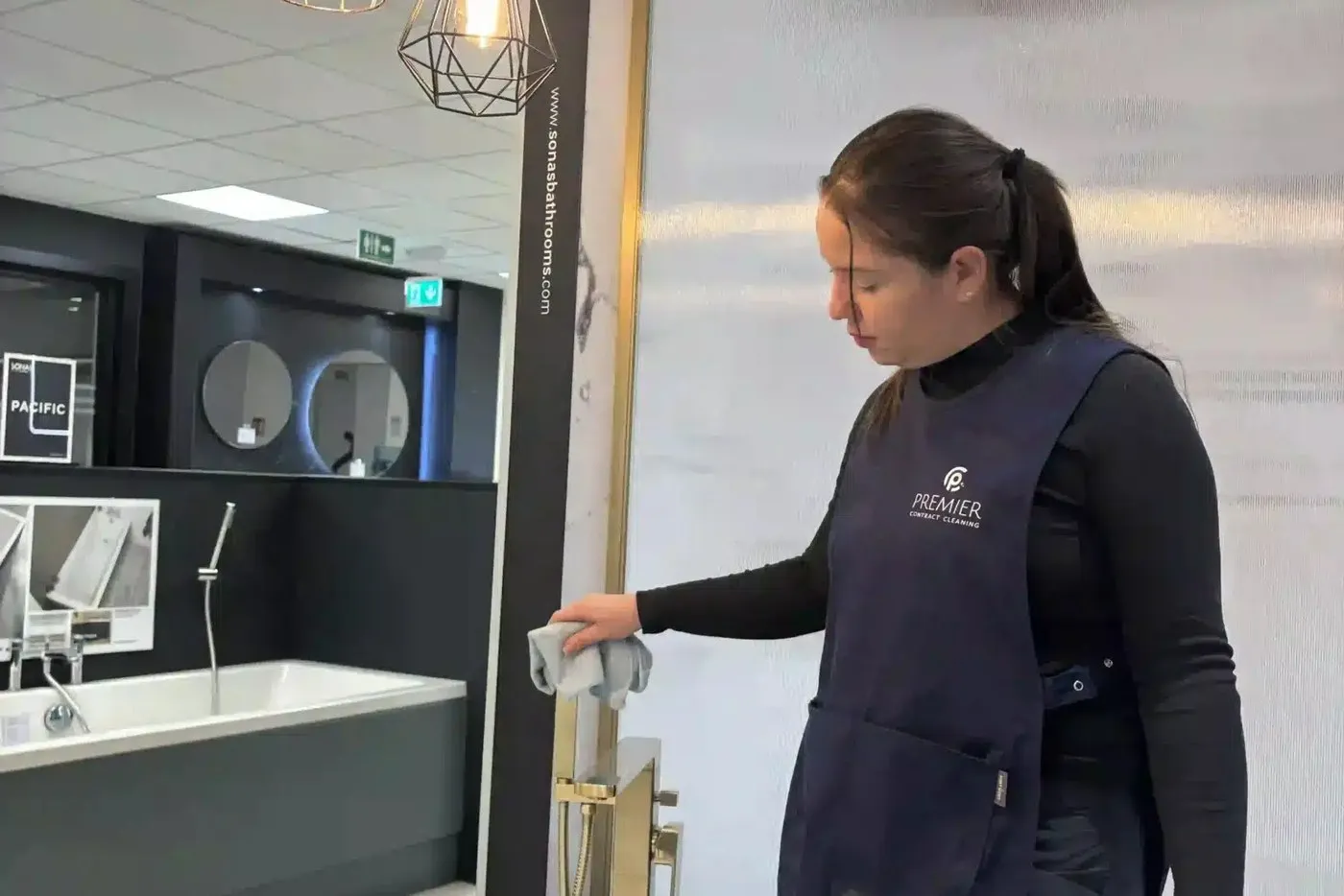Premier cleaner wiping a basin