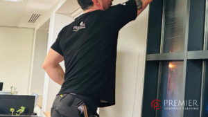 Commercial kitchen drain backing up with standing water near floor gullies while professional cleaners carry out emergency deep cleaning and food-safe disinfection in Dublin.