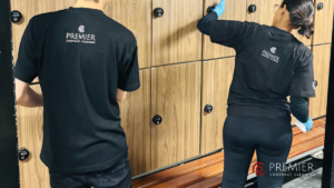 Professional gym cleaner disinfecting fitness equipment, mats, benches and changing rooms to help prevent skin infections in a Dublin gym facility.