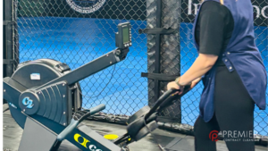Professional gym cleaner disinfecting fitness equipment, mats, benches and changing rooms to help prevent skin infections in a Dublin gym facility.